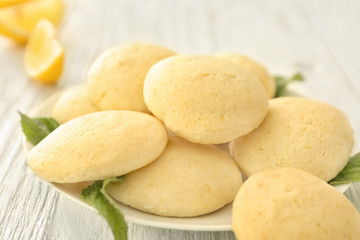 Plate with homemade lemon cookies on wooden table