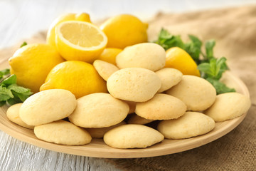 Plate with homemade lemon cookies on table, closeup