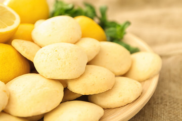 Plate with homemade lemon cookies on table, closeup