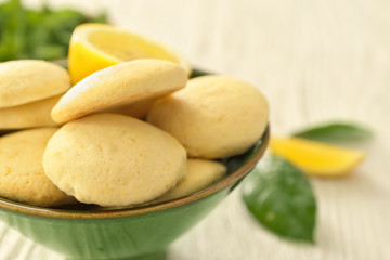 Bowl with homemade lemon cookies on table, closeup