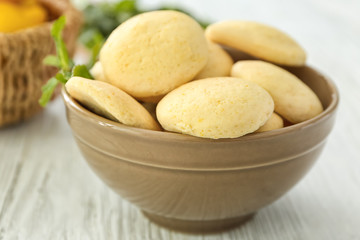 Bowl with homemade lemon cookies on wooden table