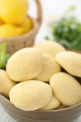 Bowl with homemade lemon cookies on table, closeup