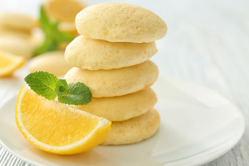 Plate with homemade lemon cookies on wooden table