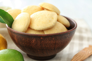 Bowl with tasty homemade lemon cookies on table