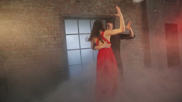 Professional dancers dancing tango in ballroom.