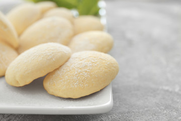 Plate with homemade lemon cookies on table