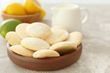 Fototapeta na wymiar Plate with homemade lemon cookies on table