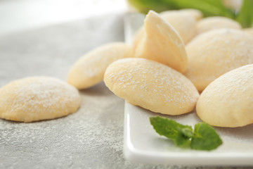 Plate with homemade lemon cookies on table