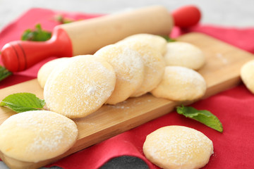 Wooden board with homemade lemon cookies on table