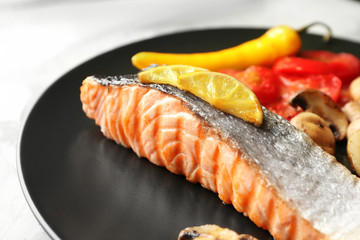 Plate with slice of delicious salmon, close up