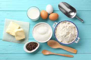 Composition with some products for cooking vanilla cake on wooden background