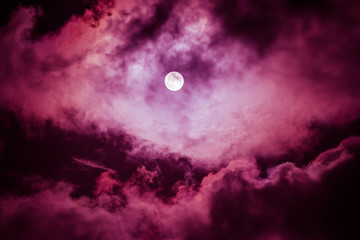 Naklejka na ściany i meble The moon on the dark sky among the clouds, natural abstract background