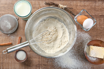 Cooking dough for vanilla cake on wooden background