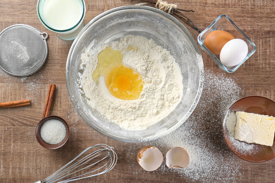 Cooking dough for vanilla cake on wooden background