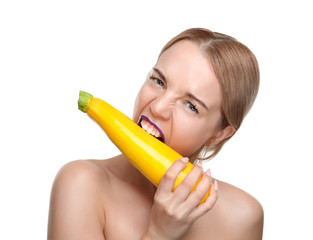 Young woman posing with yellow zucchini isolated on white