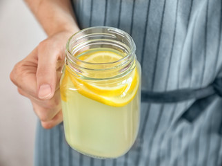 Woman holding jar of lemon juice