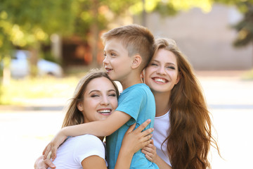 Lesbian mothers and foster son having fun outdoors