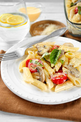 Plate with delicious roasted turkey tetrazzini on table