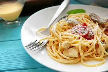 Plate with delicious roasted turkey tetrazzini on table