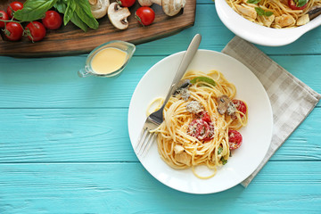 Plate with delicious roasted turkey tetrazzini on wooden background