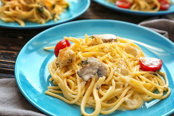 Plate with delicious turkey tetrazzini on table, close up