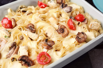 Delicious roasted turkey tetrazzini in baking dish on table, close up