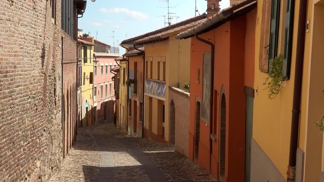 panning shot of cobbled street of the medieval village of Dozza, a small gem among the architectural wonders of Italy