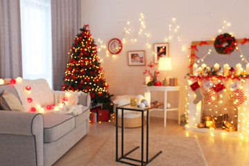Room decorated for Christmas and beautiful fir tree, blurred view