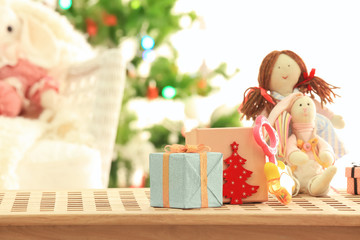 Beautiful Christmas composition with gift boxes and children toys against blurred background