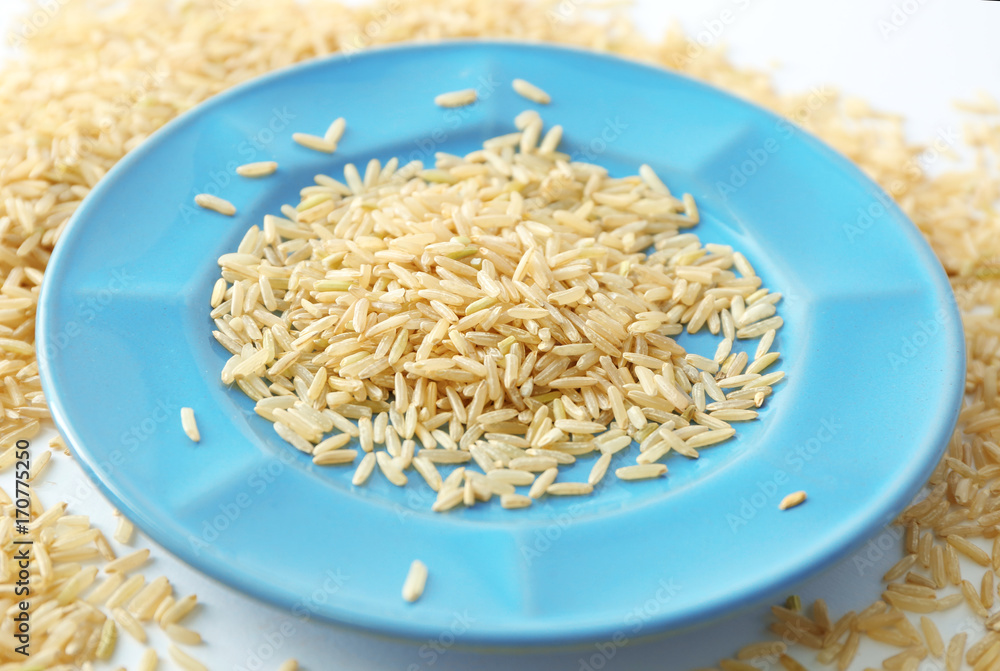 Canvas Prints plate of long grain brown rice on white background