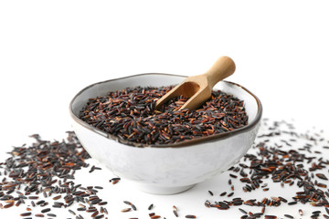 Bowl with brown rice on white background