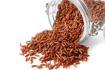 Jasmine brown rice and glass jar on white background
