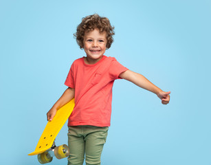 Stylish boy with yellow longboard