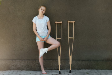 A young girl is on crutches