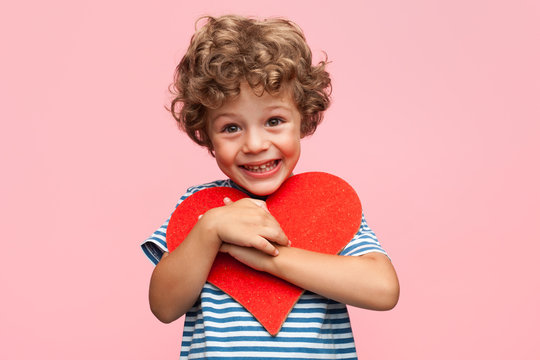 Charming boy posing with heart