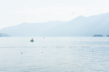 Boats on lago maggiore lake in ascona switzerland with mountain view landscape and water