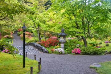 Japanese Garden Landscape on a Rainy Spring Day with Stone Bridge, Walking Paths, Stone Lantern, and Flowers, Japanese Garden Seattle Washington