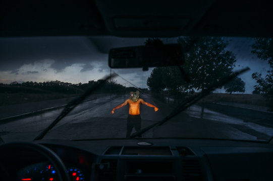 Man with sack mask on road