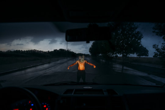 Man with sack mask on road