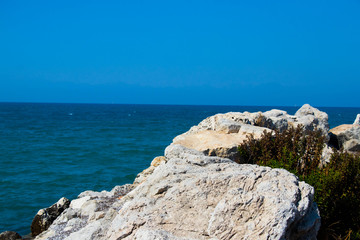 Fototapeta na wymiar white rocks against a turquoise sky on a hot sunny day
