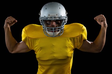 American football player flexing his muscles