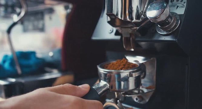 CU Shot of coffee falling from a coffee grinder machine. 4K UHD 60 FPS