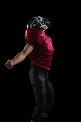 American football player posing with arms stretched open