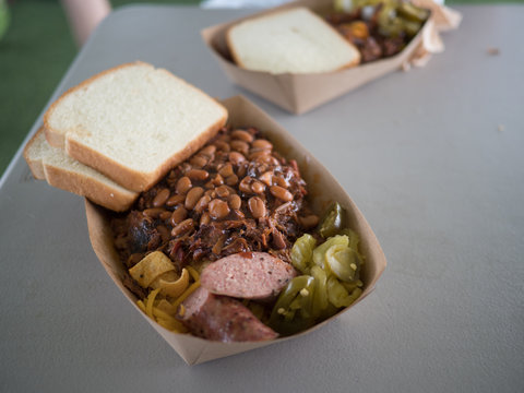 Meat piled high on top of corn chips with sausage
