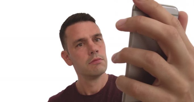Adult male holding up a cell phone and interacting with the screen