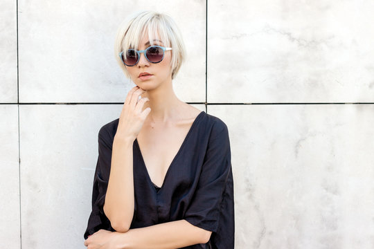 Portrait of a blond short hair female model with sunglasses