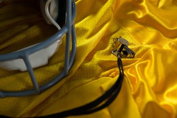 American football jersey, referee whistle and head gear