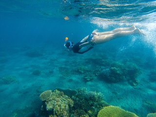 Woman swimming in blue sea. Snorkeling girl in full-face snorkeling mask.