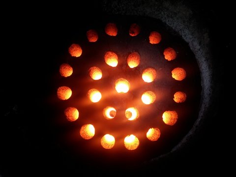 A top view of red hot coals heating up.