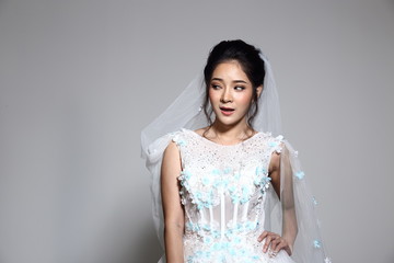 Fototapeta na wymiar Lovely Asian Beautiful Woman bride in white wedding gown dress with lace, black hair